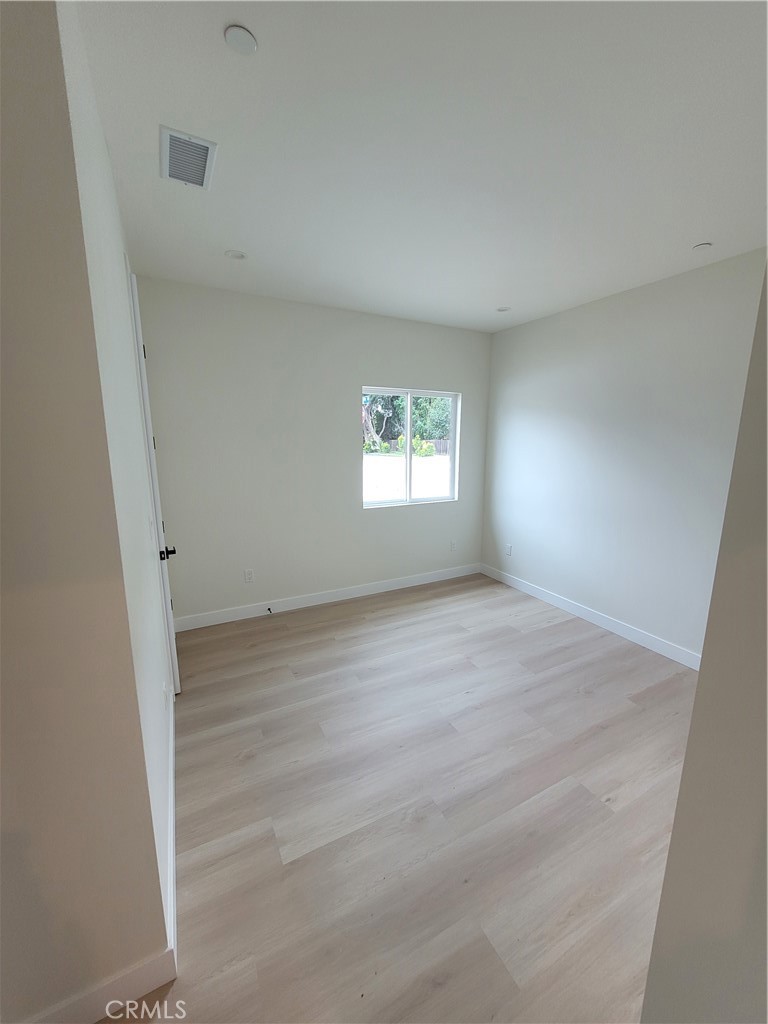 19453 Strathern Street Reseda, CA 91335 - Photo 8 of 12 a view of wooden floor and windows in a room