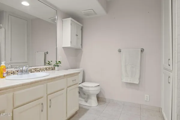 a bathroom with a sink toilet and a mirror