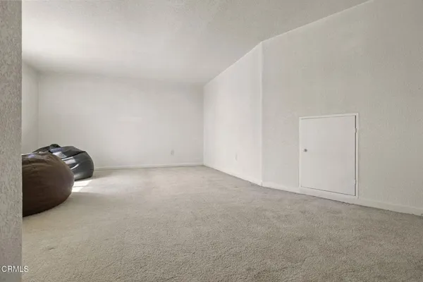 a view of an empty room and has a fan