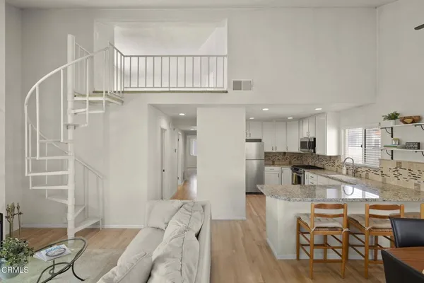 a view of a kitchen with dining table and chairs