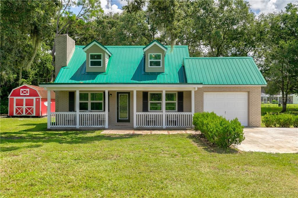 1909 North Dover Road Dover, FL 33527 - Photo 1 of 1 a front view of a house with a garden and porch