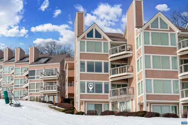 a view of a house with snow on the road