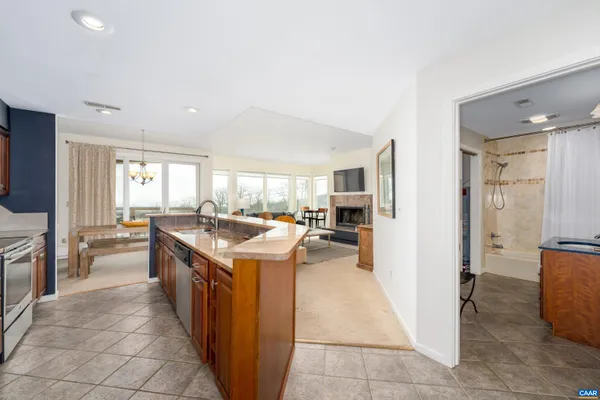 a kitchen with a sink a counter top space and stainless steel appliances