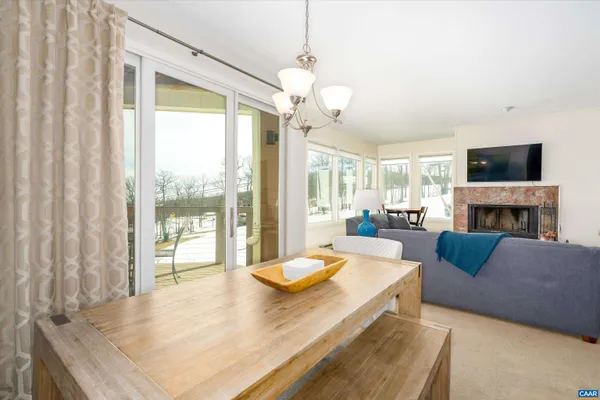 a living room with furniture a fireplace and a large window