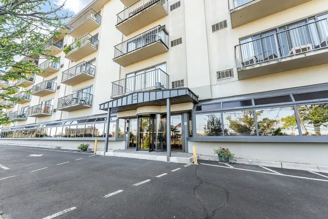 a view of a building with a window and sitting area