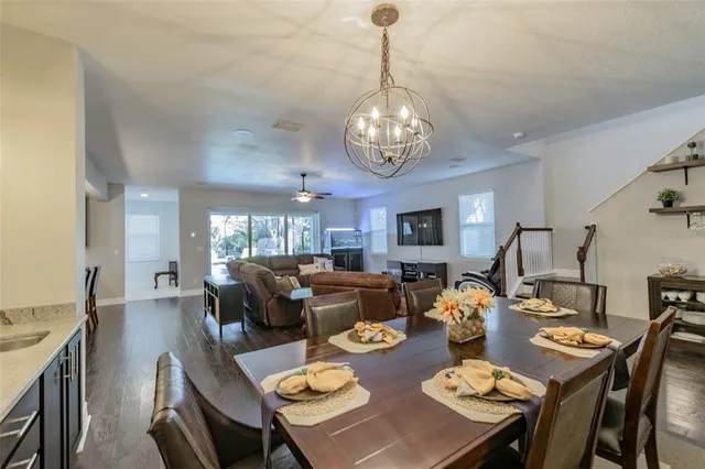 a view of a dining room with furniture and chandelier