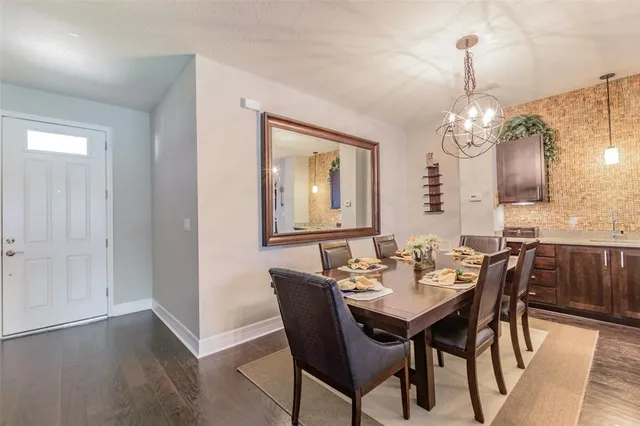 a large kitchen with a table and chairs