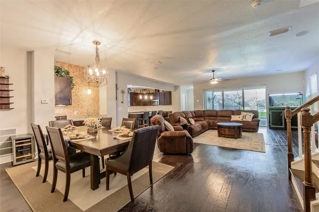 a kitchen with stainless steel appliances granite countertop a sink a stove and a wooden floors