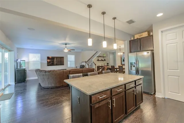 a kitchen with kitchen island a sink counter space and stainless steel appliances
