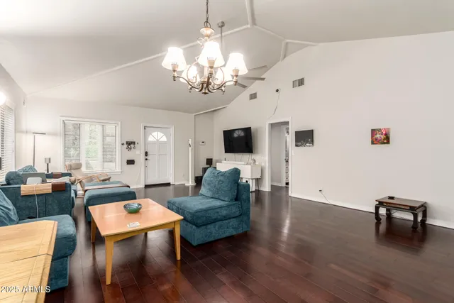 a living room with furniture or chandelier and a wooden floor