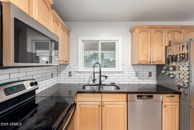 a kitchen with granite countertop a sink and a window