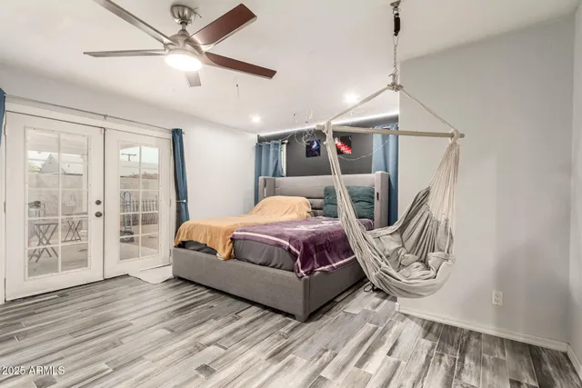 a bedroom with a bed and wooden floor