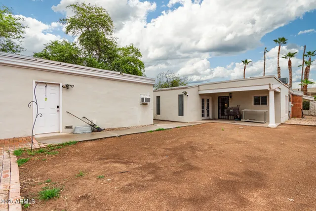 a view of a house with a backyard and a garage