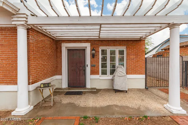 a view of a patio with table and chairs and wooden fence
