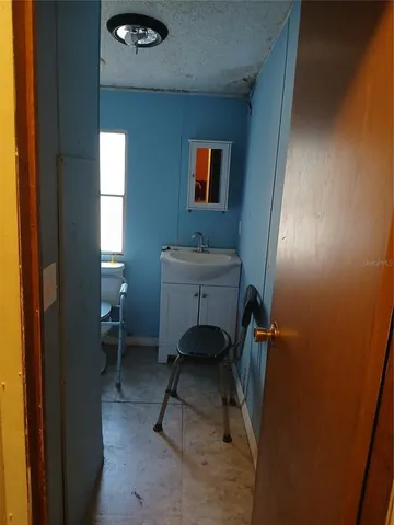 a blue chair sitting in a dinning room next to a window