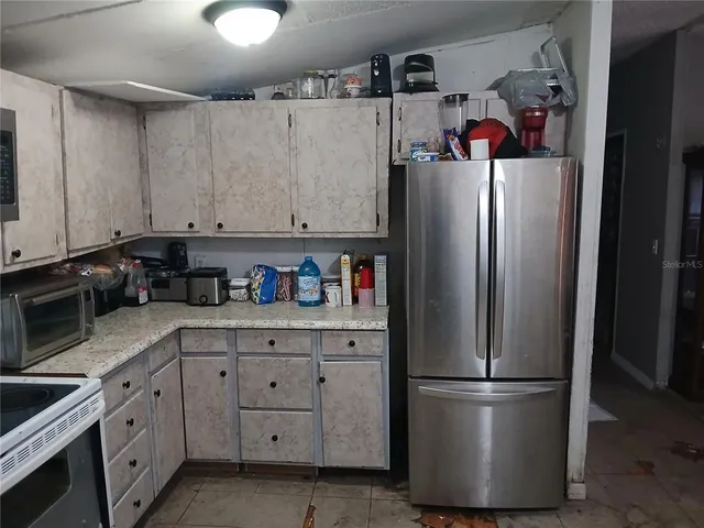 a white refrigerator freezer sitting in a kitchen
