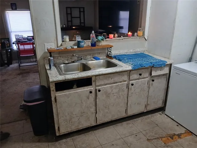 a kitchen with a sink and cabinets