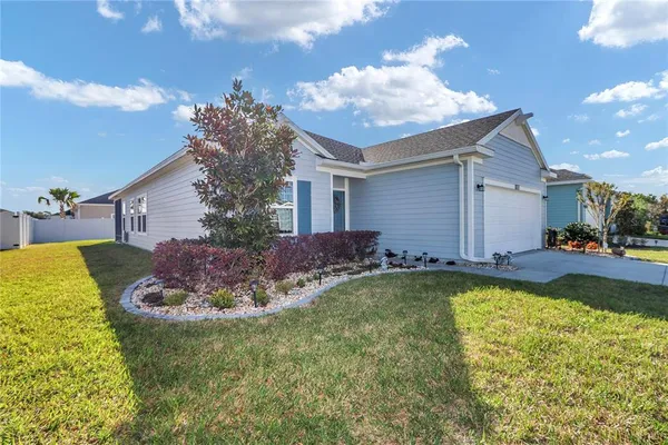 a view of a house with swimming pool and a yard