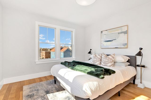 a bedroom with bed and a window