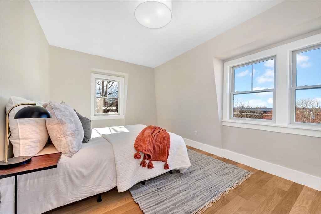 6 Berkeley Street Somerville, MA 02143 - Photo 24 of 41 a bed sitting in a bedroom next to a window