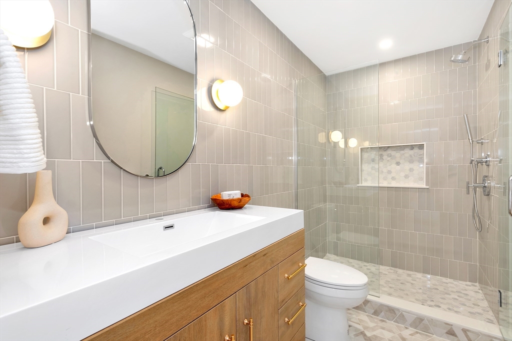 6 Berkeley Street Somerville, MA 02143 - Photo 25 of 41 a bathroom with a sink a toilet and a mirror