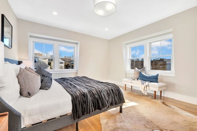 a bedroom with a bed and a large window