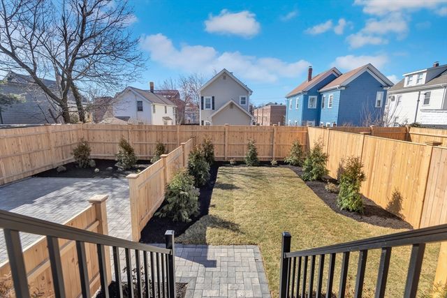 a view of a house with wooden fence