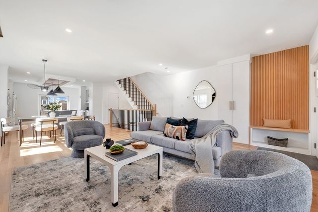 a living room with furniture a rug and a window