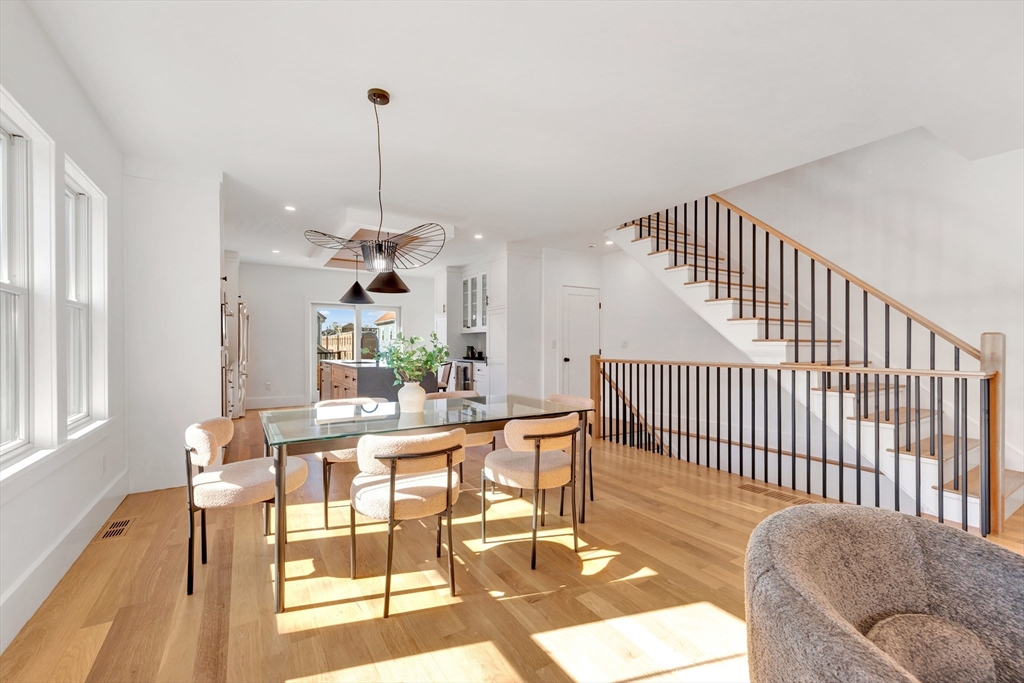 6 Berkeley Street Somerville, MA 02143 - Photo 10 of 41 a dining room with furniture a chandelier and wooden floor
