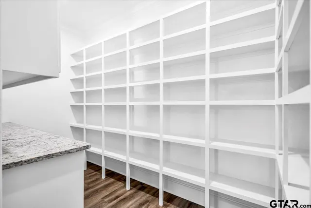 a view of walk in closet with empty racks