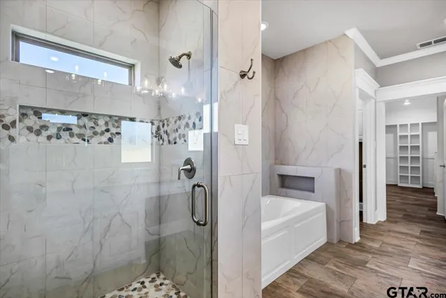 a bathroom with a bathtub and a shower