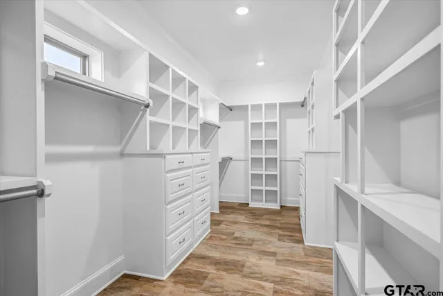 a view of walk in closet with empty racks