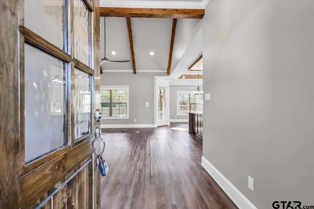 a view of hallway with wooden floor and staircase
