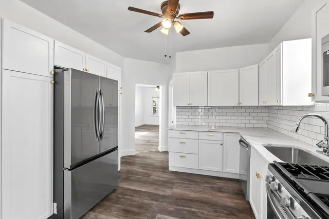 a kitchen with stainless steel appliances a refrigerator sink and cabinets