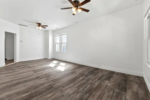 wooden floor in an empty room with a window