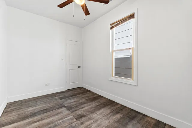 an empty room with a empty space and a ceiling fan