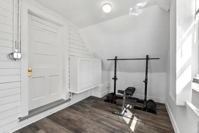 a view of a room with wooden floor and furniture
