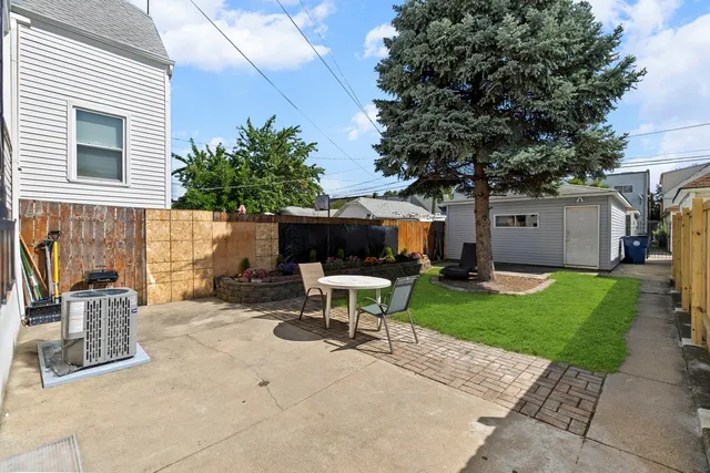 a view of a patio with a table and chairs in a patio