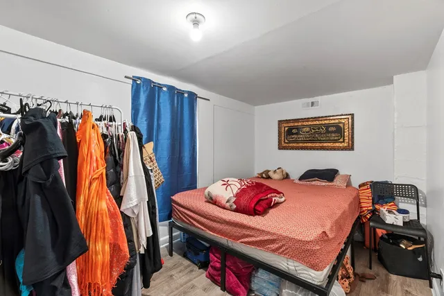 a bedroom with a bed and a closet