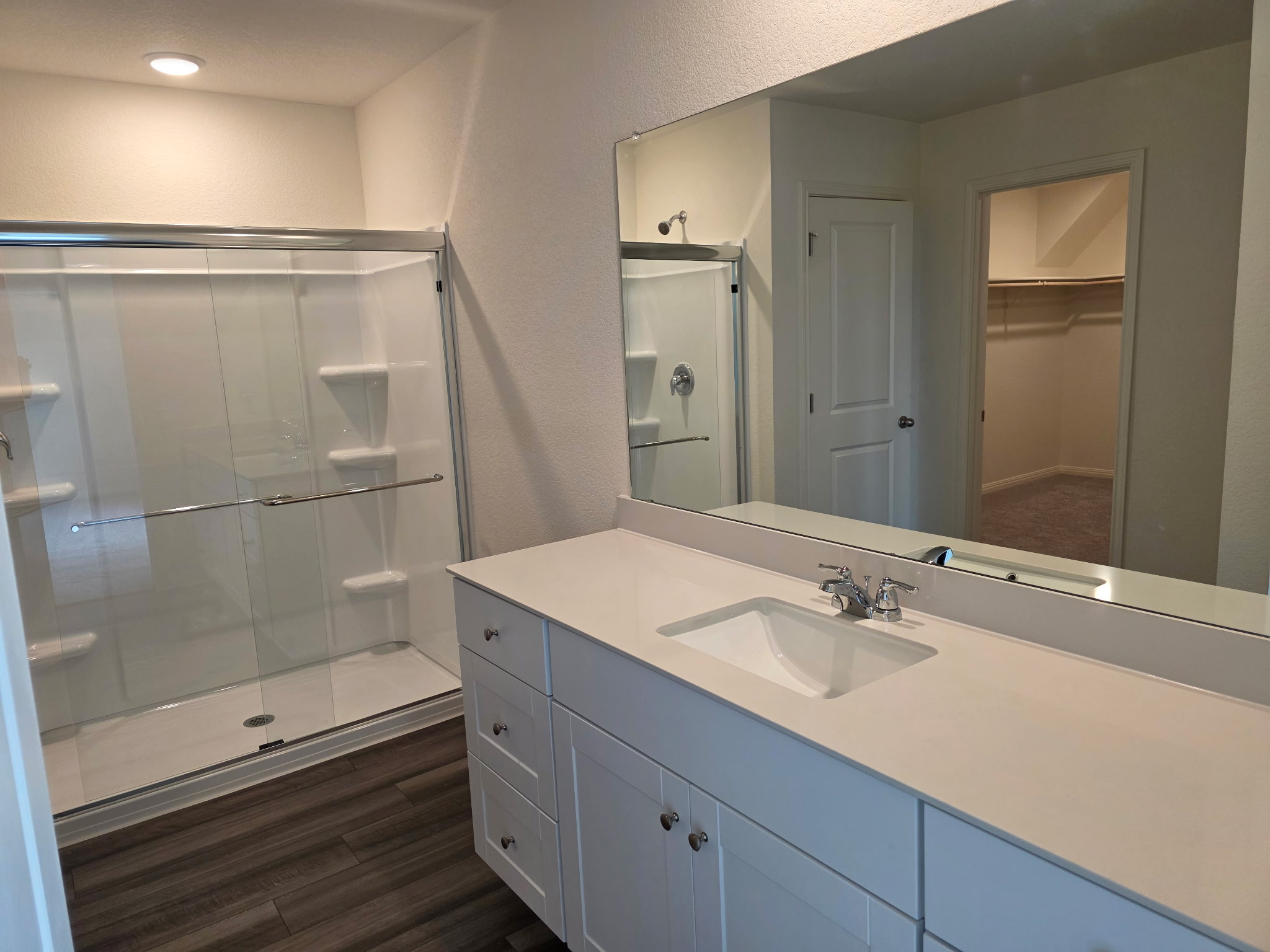 353 Enforcer Loop Jarrell, TX 76537 - Photo 20 of 21 Full bath with a shower stall, vanity, a walk in closet, and wood finished floors