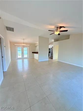 a view of a livingroom with furniture and chandelier fan