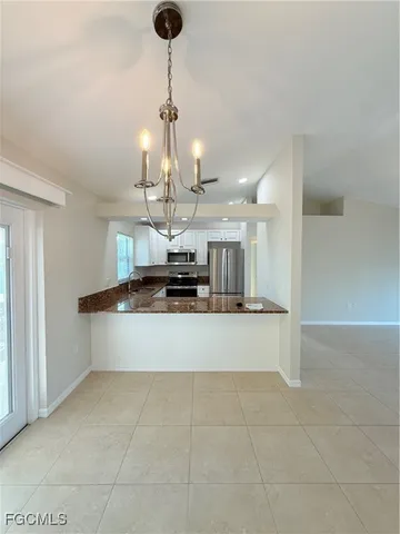 a large kitchen with a counter space a sink and refrigerator