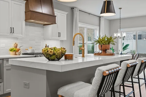 a kitchen with a table and chairs