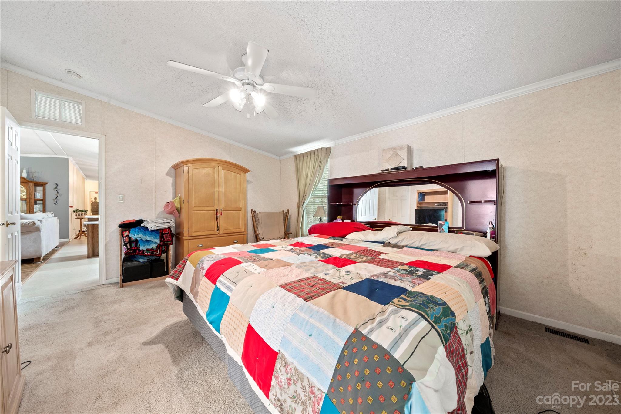 442 Tirzah Church Road Lancaster, SC 29720 - Photo 15 of 29 a bedroom with a large bed and a chandelier