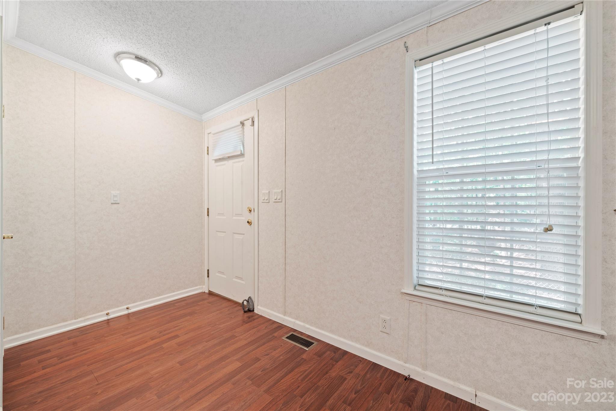442 Tirzah Church Road Lancaster, SC 29720 - Photo 3 of 29 a view of an empty room with wooden floor and a window