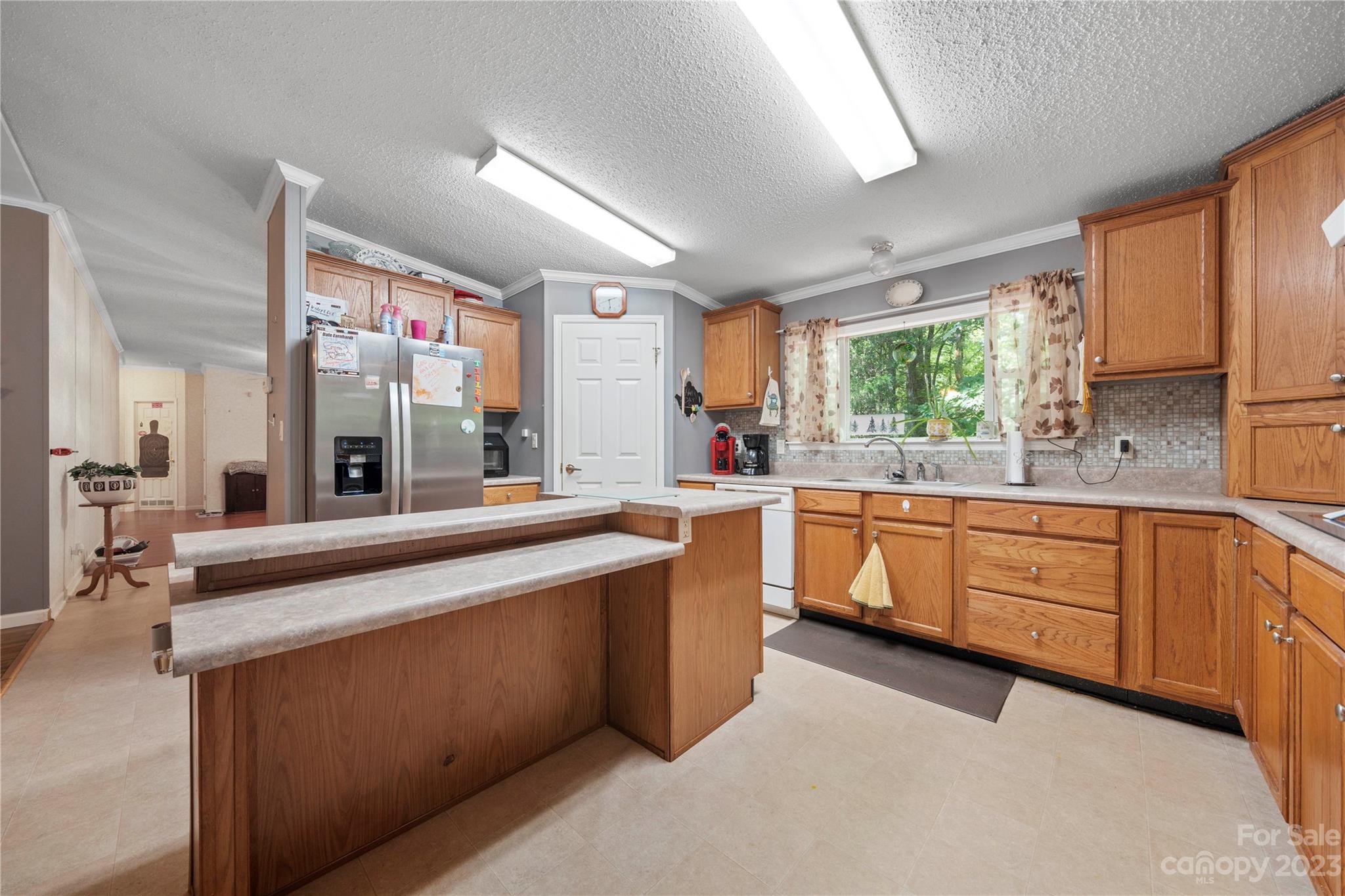 442 Tirzah Church Road Lancaster, SC 29720 - Photo 8 of 29 a large kitchen with kitchen island granite countertop a large window and white cabinets