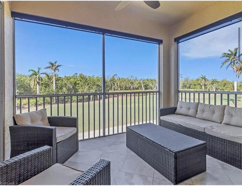 4650 Yacht Harbor Drive, Unit 125 Naples, FL 34112 - Photo 11 of 20 a living room with furniture and a floor to ceiling window