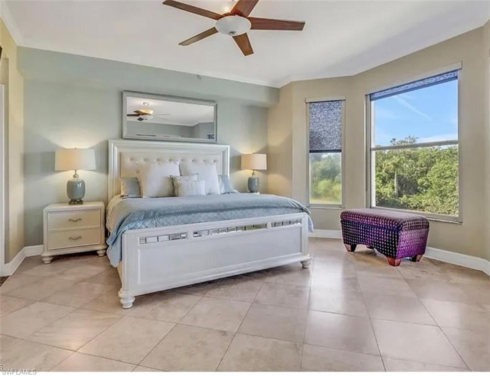 4650 Yacht Harbor Drive, Unit 125 Naples, FL 34112 - Photo 12 of 20 a bedroom with a large bed and a window