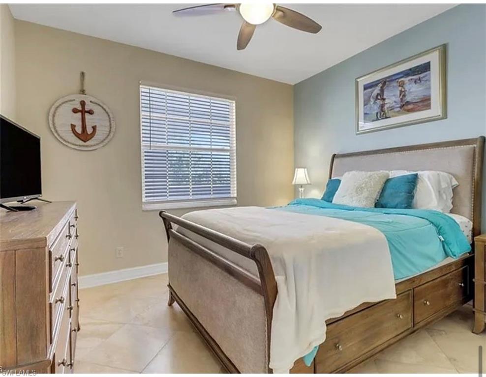 4650 Yacht Harbor Drive, Unit 125 Naples, FL 34112 - Photo 16 of 20 a bedroom with a bed and a flat screen tv