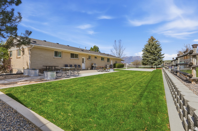 2420 West Old Hwy Road Morgan, UT 84050 - Photo 42 of 54 Back of property with a lawn, a patio, a mountain view, and pickleball court